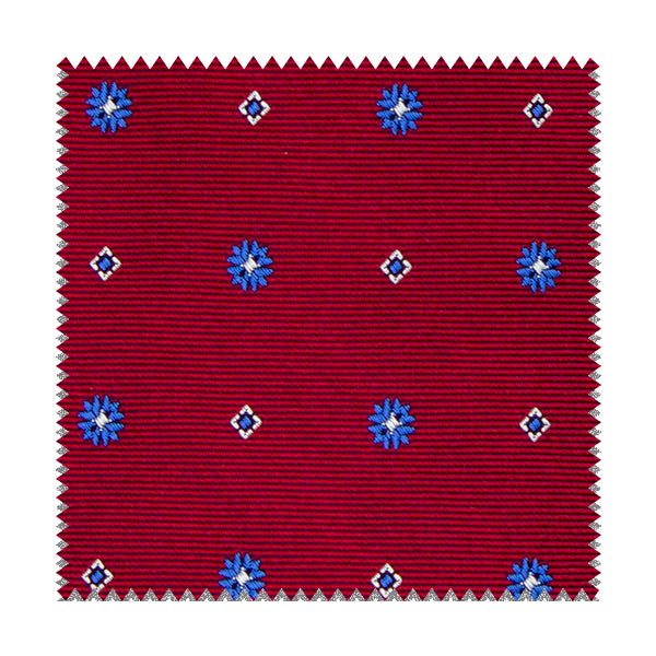 Tessuto blu con fiori bianchi e quadratini gialli