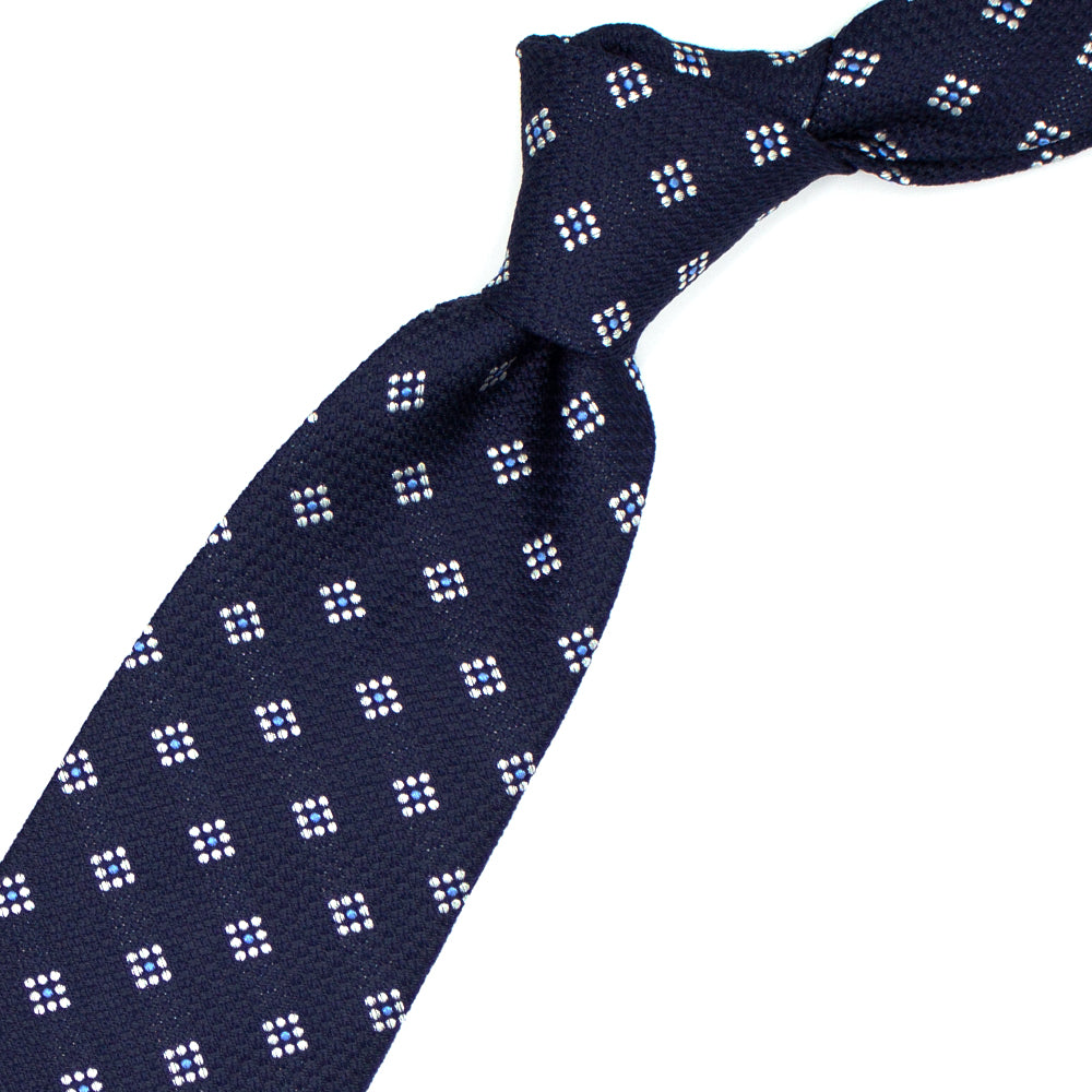 Cravatta blu con pattern geometrico grigio e azzurro