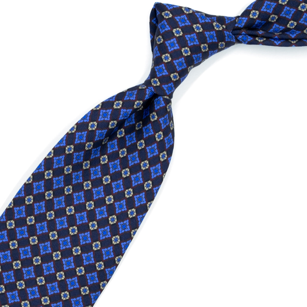 Cravatta blu con pattern azzurro, crema e bordeaux