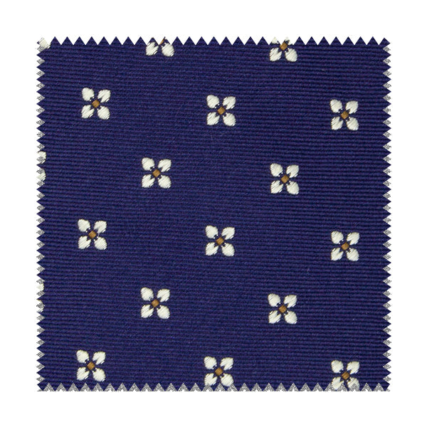 Tessuto blu con fiori bianchi e quadratini gialli