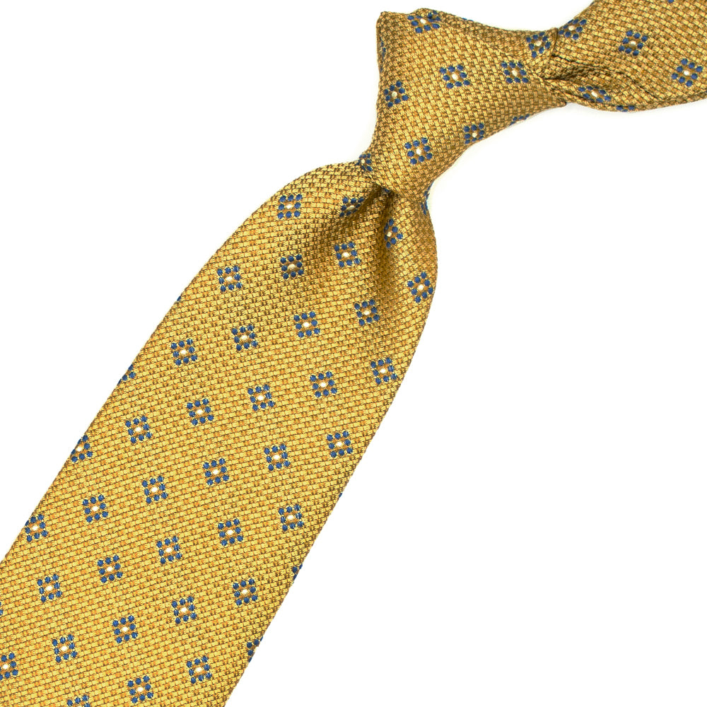 Cravatta gialla con pattern geometrico azzurro e bianco