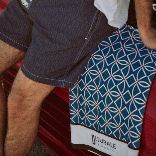 Beach towel with geometric pattern on a blue background